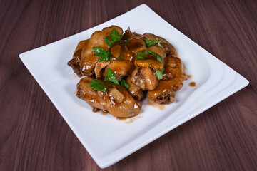 Cola chicken wings on a white plate