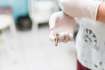 otolaryngological funnel for examining the ear in the hands of a doctor
