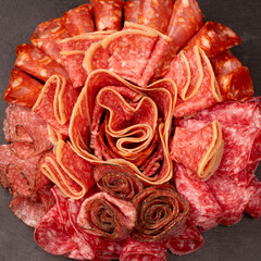 Different kinds of meat cuts on a board.