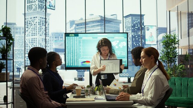 Business associates reviewing key performance indicators within the enterprise activity. Conducting evaluations and discuss training to foster development, enhance team efficiency. Camera B.