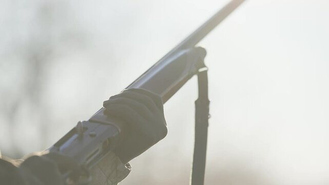 The hunter checks his rifle