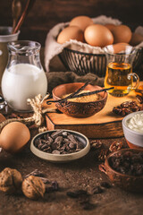 Assorted baking ingredients and kitchen utensils in brown tone