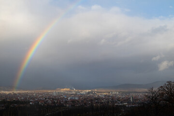 A rainbow over the city after the rain.