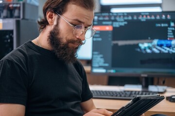 Side view, by computer with 3d printer. Man is in the modern office, one person