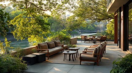 Obraz premium Serene outdoor patio by the river with cozy seating, greenery, and a peaceful space for unwinding and enjoying nature.