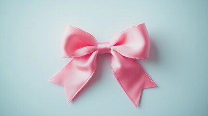 A charming pink bow resting on a clean white surface, symbolizing simplicity and elegance.