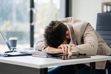 Young stressed caucasian businessman working in the office. Businessman thinking too much work...