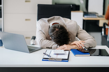 Young stressed caucasian businessman working in the office. Businessman thinking too much work...