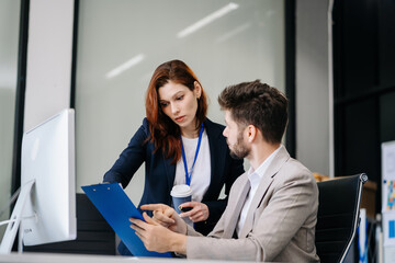 Diverse professionals collaborate on project analysis with financial graphs. Strategic teamwork and insights drive company growth and success.