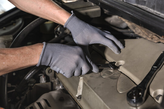 Close up car mechanic hand holding mechanic tools working in auto repair service shop
