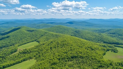 Naklejka premium A drone view of a green mountain range with layered peaks stretching into the distance