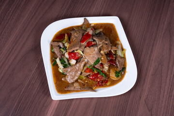 Pork liver with hot and sour pickled peppers on a white plate