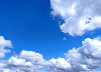 Clear blue sky texture and white fluffy cloud nature background. The sun shines bright in the daytime in summer