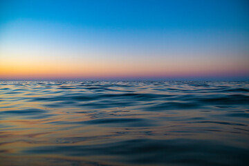 Obraz premium Sunset over sea background with empty space for text. View at water level.