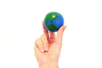 Hand Holding a Foam Globe Against a White Background