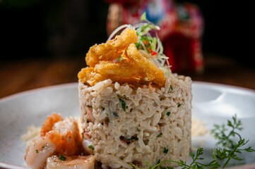 Gourmet seafood risotto with crispy onion rings