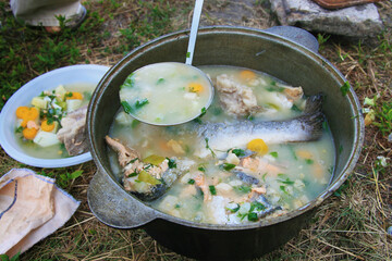 Delicious fish soup cooked outdoors in a cauldron. Perfect for a camping trip