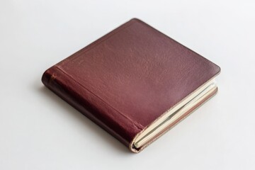 Obraz premium a brown leather journal or notebook resting on a white surface