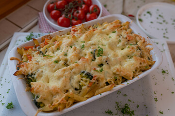 Homemade vegetarian pasta vegetable casserole in a baking dish on kitchen counter