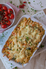 Vegetarian vegetable pasta casserole with cheese crust in a white baking dish