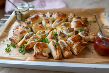 Puff pastry filled with bratwurst or fried sausage and served as a party wreath