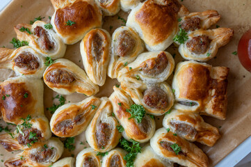 Puff pastry filled with bratwurst or fried sausage and served as a party wreath