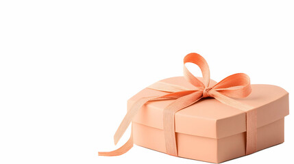 Obraz premium Peach heart-shaped gift box with ribbon, isolated on white background; perfect for Valentine's, birthday, or anniversary celebrations.