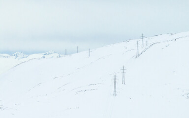 Power line in winter mountain.High voltage line over the mountain. Norwegian winter mountain.