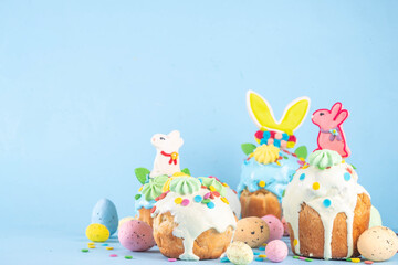 Bright colorful Easter cakes, pastries and eggs greeting card background with copy space,  Easter cooking concept, sweet treats sale, Easter party, spring baking fair invitation