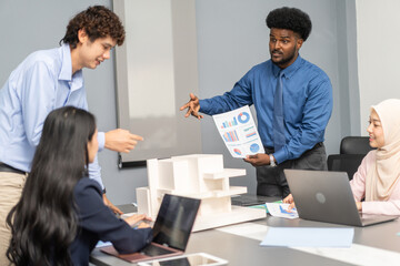 Architects engineers collaborating on building design project in modern office, diverse team of professionals female muslim architect and male engineers discussing architectural model of structure