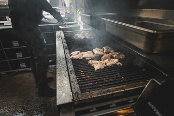 Chef grilling meat at a street food festival