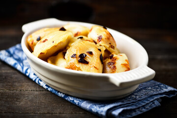 Dumplings with potato and cottage cheese stuffing (pierogi). Wooden background. Copy space.