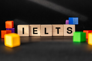 IELTS written on wooden blocks (International English Language Testing System) Conceptual symbol, Education and international work requiring good English language skills