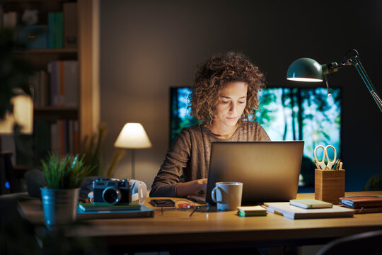 Young woman working on her laptop at home