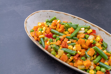 Mexican Mix of Vegetables. Tomatoes, Green Beans, Peas, Corn. Dietary Food.Bright vegetable mix .Vegetarian food.Assorted.