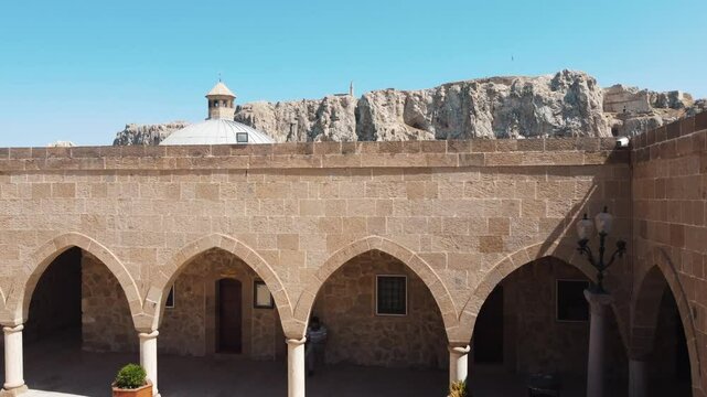In this shot, the Old City of Van and the Suleyman Han Mosque on the rocks are seen from the courtyard of the Kose Husrev Mosque. The drone lands in the mosque courtyard.