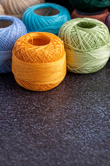 Multicolor yarn for knitting, knitting needles and scissors. Home storage concept and hobby.Raffia is an organic, ecological, wood fiber that is easy to crochet.