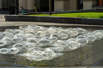 A modern water fountain works in the Kyiv historical area on metro Arsenalna during spring or summer. Refreshing urban solution during hot days.