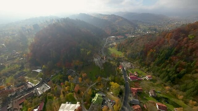 Stunning aerial view over the Bran Castle, Transylvania, Romania on a partial cloudy day. Wonderful autumn vibe.