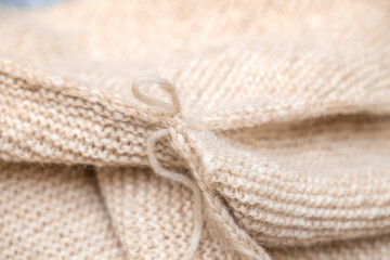 Close up of hands of unrecognizable woman knitting handmade clothes with spokes using  wool yarn. Concept of leisure activity.Knitting from yarn on  coarse spokes.