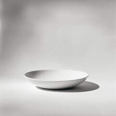 a plain white bowl sits on a white surface