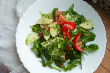 Fresh green salad with cucumber and tomato, healthy and delicious.