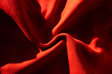 Close-up of textured red fabric.  Rich color and dramatic folds create a luxurious feel.