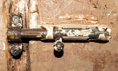 The latch is an old Soviet one.The door latch.The latch for the door.Shutter photo.