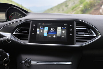 Modern car interior detail: climate control and infotainment screen