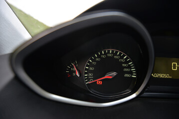 Close up of a car's dashboard with speedometer fuel gauge and odometer