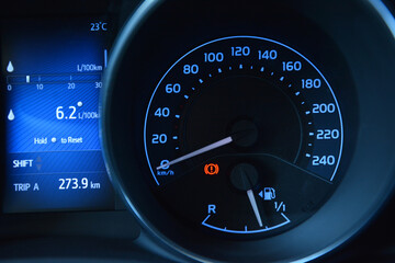 Car dashboard showing speed fuel level and trip information