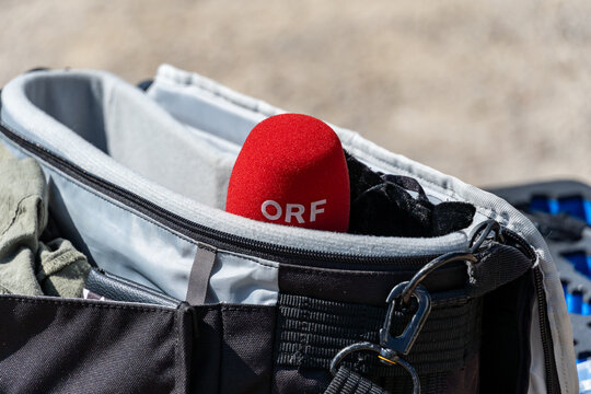 Close-up of a red microphone of the Austrian television ORF in a travel bag.