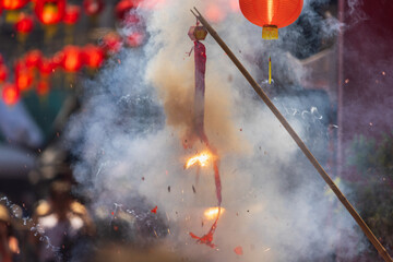 Traditional Chinese firecrackers are exploding with flashes and smoke in Lunar new year.