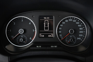 Close up of a car's instrument panel displaying speed RPM and trip information